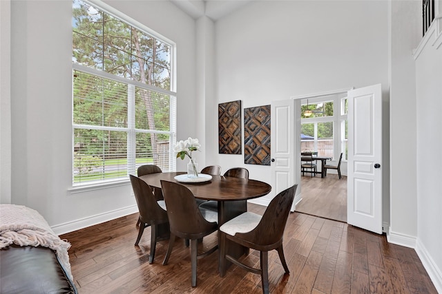 135 Wisteria Walk Cir, The Woodlands, TX 77381 - dining space featuring dark wood finished floors, healthy amount of natural light, and a towering ceiling