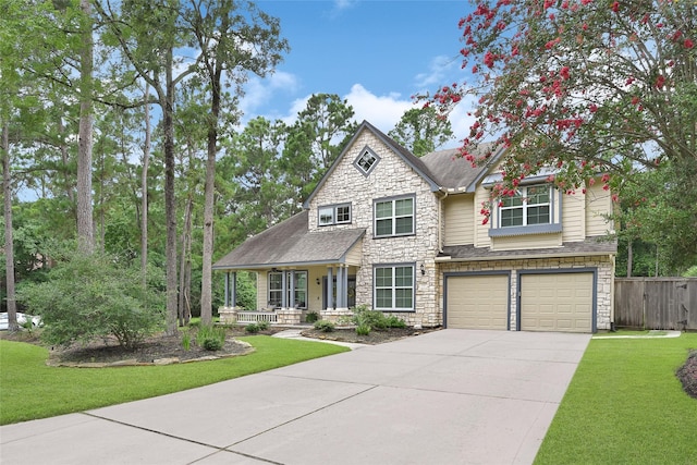 135 Wisteria Walk Cir, The Woodlands, TX 77381 - craftsman-style home featuring a porch, stone siding, a garage, concrete driveway, and a shingled roof