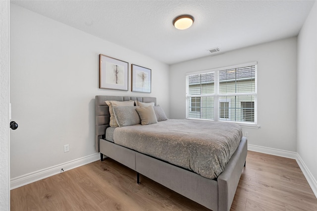 135 Wisteria Walk Cir, The Woodlands, TX 77381 - bedroom with baseboards and wood finished floors