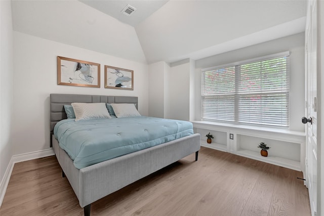 135 Wisteria Walk Cir, The Woodlands, TX 77381 - bedroom with light wood finished floors and vaulted ceiling