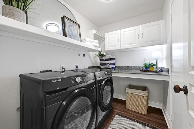 135 Wisteria Walk Cir, The Woodlands, TX 77381 - laundry room with washing machine and clothes dryer, dark wood-style floors, and cabinet space