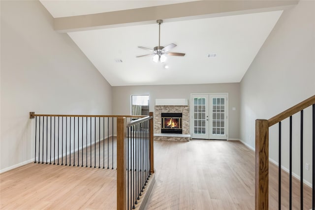 3802 Knollcrest Dr, Montgomery, TX 77356 - unfurnished living room with vaulted ceiling, a ceiling fan, wood finished floors, and a stone fireplace