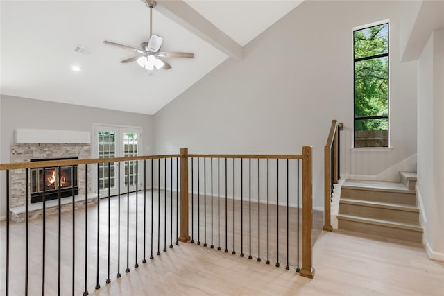 3802 Knollcrest Dr, Montgomery, TX 77356 - stairway with vaulted ceiling, healthy amount of natural light, a ceiling fan, a stone fireplace, and wood finished floors