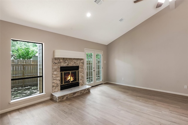 3802 Knollcrest Dr, Montgomery, TX 77356 - unfurnished living room featuring plenty of natural light, a stone fireplace, wood finished floors, vaulted ceiling, and a ceiling fan
