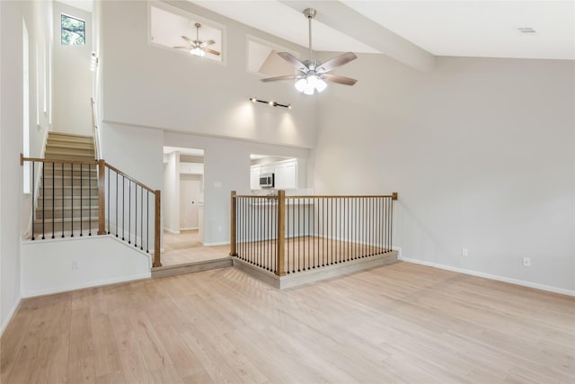 3802 Knollcrest Dr, Montgomery, TX 77356 - unfurnished room featuring a ceiling fan, light wood finished floors, beamed ceiling, and high vaulted ceiling