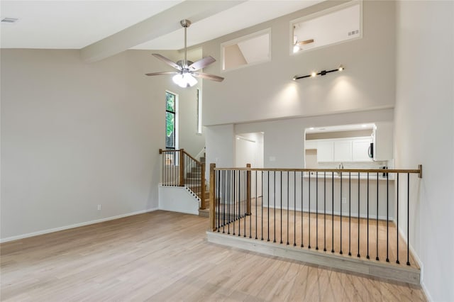 3802 Knollcrest Dr, Montgomery, TX 77356 - empty room with ceiling fan, wood finished floors, beamed ceiling, and high vaulted ceiling