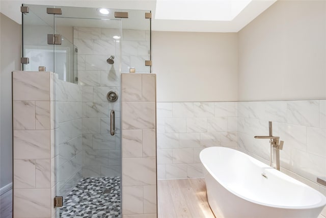 3802 Knollcrest Dr, Montgomery, TX 77356 - bathroom with a freestanding bath, a shower stall, tile walls, and wood finished floors