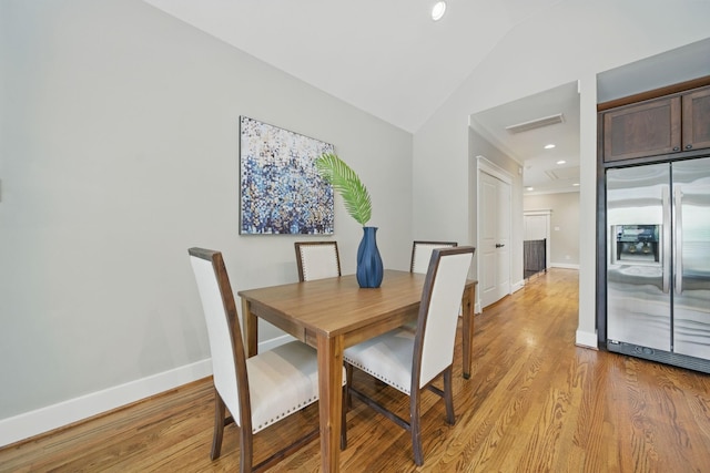 1028 Dunbar St, Houston, TX 77009 - dining space featuring light wood-style floors, vaulted ceiling, and recessed lighting