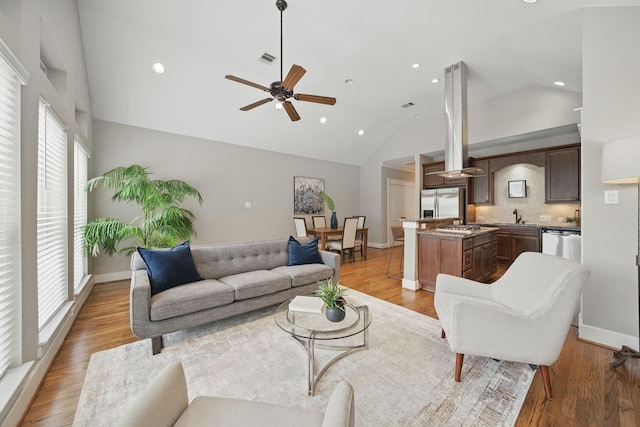 1028 Dunbar St, Houston, TX 77009 - living room featuring plenty of natural light, ceiling fan, recessed lighting, high vaulted ceiling, and wood finished floors
