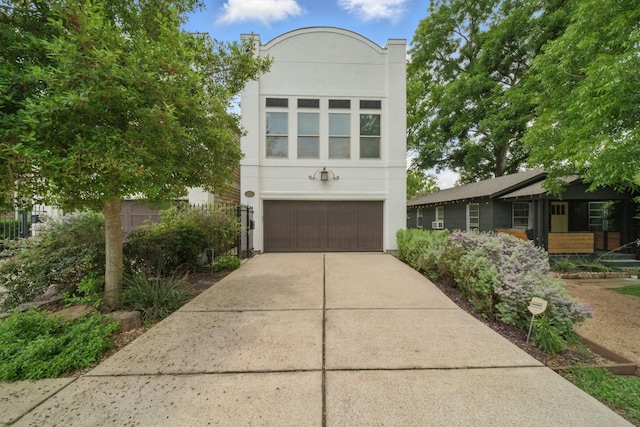 1028 Dunbar St, Houston, TX 77009 - view of front of property featuring stucco siding, a garage, and concrete driveway