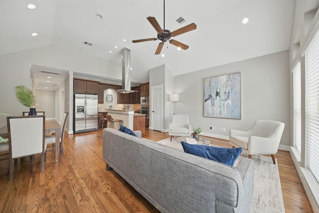 1028 Dunbar St, Houston, TX 77009 - living area with vaulted ceiling, ceiling fan, light wood-type flooring, and recessed lighting