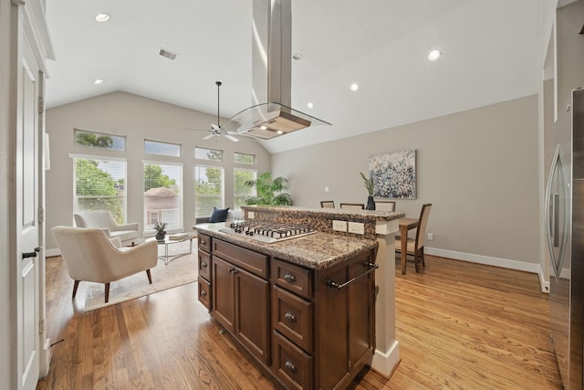 1028 Dunbar St, Houston, TX 77009 - kitchen featuring stainless steel gas cooktop, lofted ceiling, a ceiling fan, dark brown cabinets, and light wood-style floors