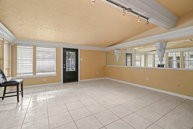 7847 Broadview Dr, Houston, TX 77061 - entryway featuring vaulted ceiling, a textured ceiling, light tile patterned floors, rail lighting, and crown molding