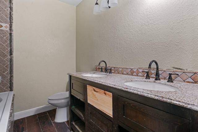 7847 Broadview Dr, Houston, TX 77061 - bathroom featuring double vanity, a bath, backsplash, and wood finished floors