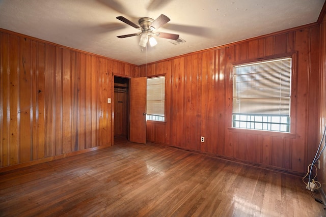 7847 Broadview Dr, Houston, TX 77061 - unfurnished room featuring wood finished floors, ceiling fan, and wooden walls