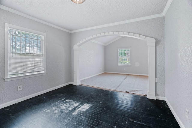 7847 Broadview Dr, Houston, TX 77061 - empty room with a textured wall, arched walkways, ornamental molding, a textured ceiling, and wood finished floors