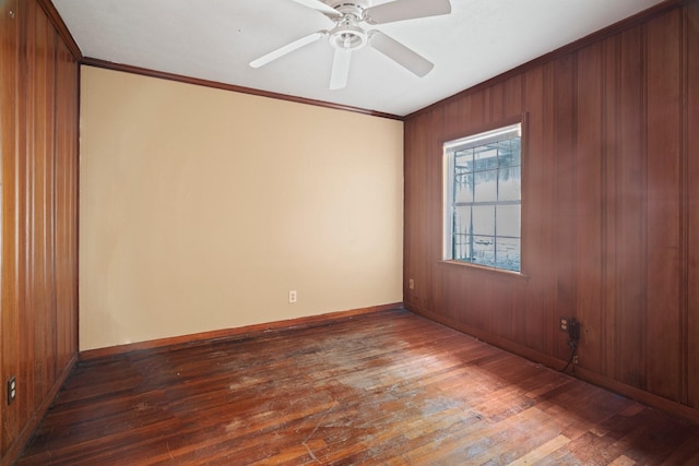 7847 Broadview Dr, Houston, TX 77061 - empty room with dark wood-style floors, crown molding, wood walls, and a ceiling fan