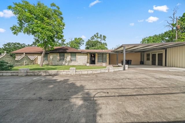 7847 Broadview Dr, Houston, TX 77061 - ranch-style home featuring an attached carport, a front yard, driveway, and stone siding