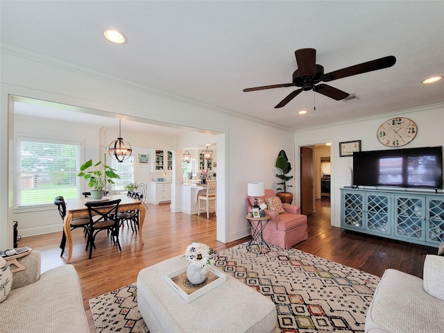 505 S Jackson St, Brenham, TX 77833 - living area featuring wood finished floors, crown molding, ceiling fan, and recessed lighting