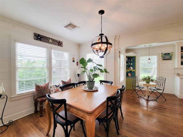 505 S Jackson St, Brenham, TX 77833 - dining space featuring wood finished floors, a chandelier, and crown molding