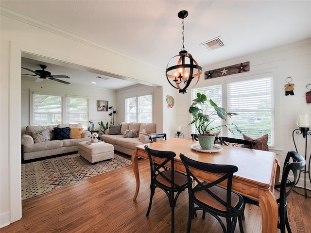 505 S Jackson St, Brenham, TX 77833 - dining room with wood finished floors, a chandelier, crown molding, and a ceiling fan