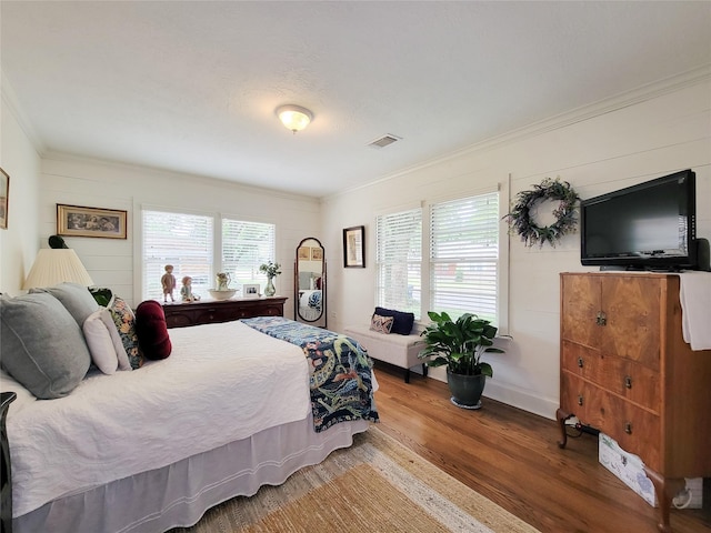 505 S Jackson St, Brenham, TX 77833 - bedroom featuring crown molding, wood finished floors, and multiple windows