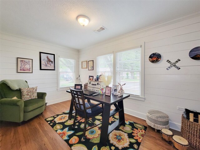 505 S Jackson St, Brenham, TX 77833 - dining space with wood finished floors, crown molding, and wooden walls