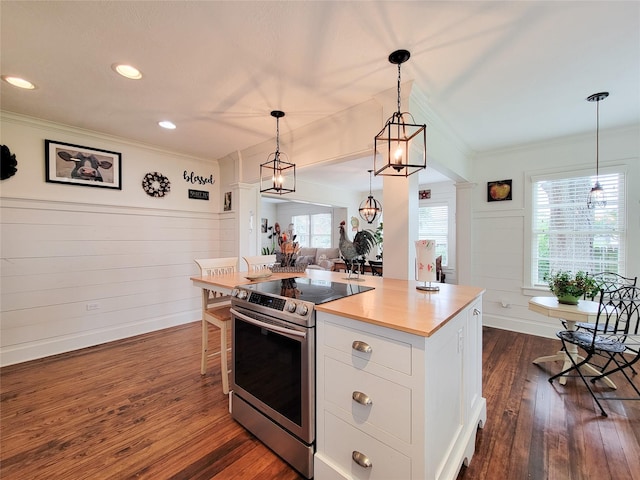 505 S Jackson St, Brenham, TX 77833 - kitchen with stainless steel electric range oven, ornamental molding, white cabinets, dark wood-type flooring, and pendant lighting
