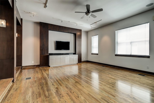 1820 Prospect St, Houston, TX 77004 - unfurnished living room featuring track lighting, light wood-style flooring, and ceiling fan