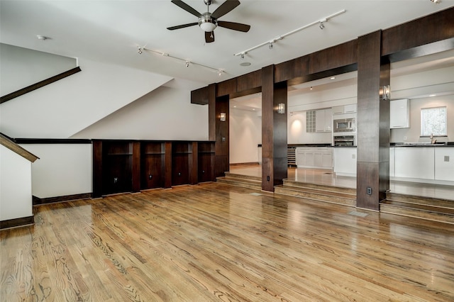 1820 Prospect St, Houston, TX 77004 - unfurnished living room featuring track lighting, light wood-style flooring, and a ceiling fan