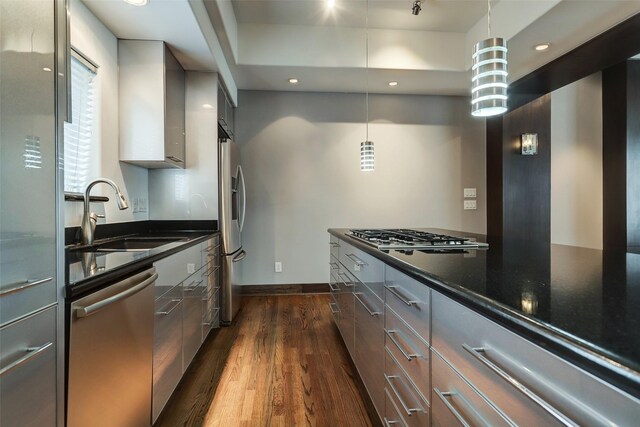 1820 Prospect St, Houston, TX 77004 - kitchen with appliances with stainless steel finishes, modern cabinets, dark wood-style flooring, dark stone countertops, and recessed lighting