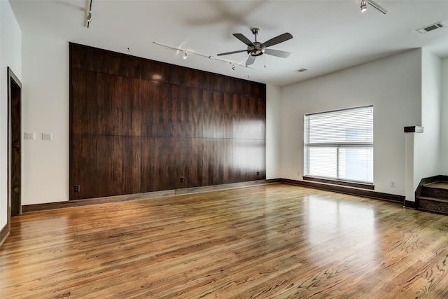 1820 Prospect St, Houston, TX 77004 - spare room featuring track lighting, wood finished floors, and ceiling fan