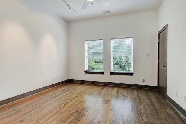 1820 Prospect St, Houston, TX 77004 - spare room featuring wood finished floors, a ceiling fan, and rail lighting