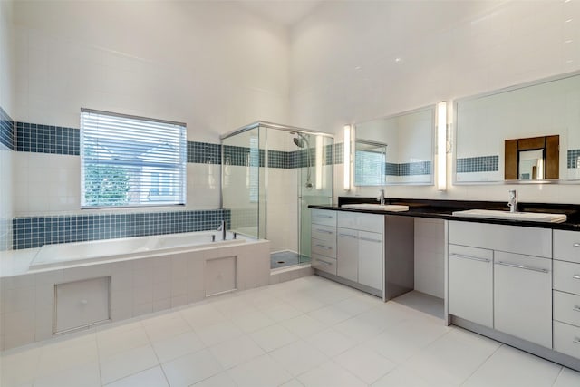 1820 Prospect St, Houston, TX 77004 - full bath with a shower stall, vanity, a bath, and tile patterned flooring