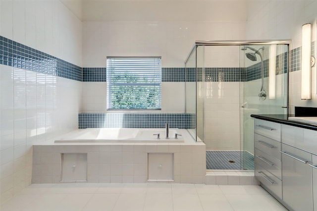 1820 Prospect St, Houston, TX 77004 - full bath featuring a garden tub, a shower stall, tile walls, tile patterned floors, and vanity
