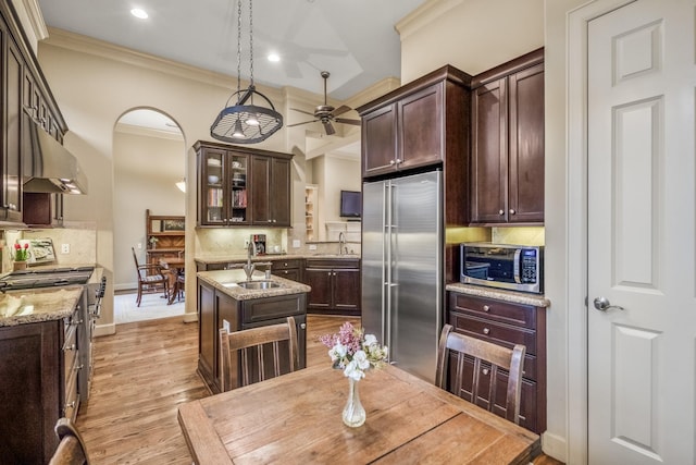 5023 La Branch St, Houston, TX 77004 - kitchen with stainless steel appliances, under cabinet range hood, crown molding, a ceiling fan, and backsplash