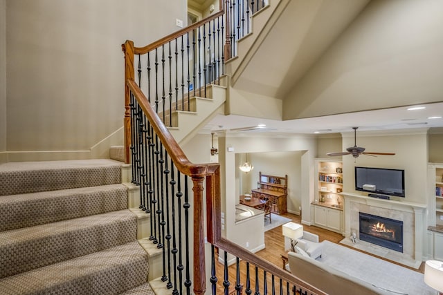 5023 La Branch St, Houston, TX 77004 - stairway with a premium fireplace, ceiling fan, wood finished floors, a high ceiling, and recessed lighting