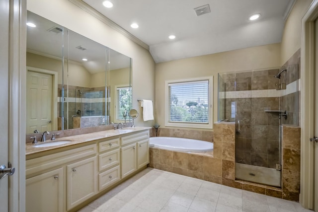 5023 La Branch St, Houston, TX 77004 - bathroom with a shower stall, double vanity, a garden tub, tile patterned floors, and crown molding