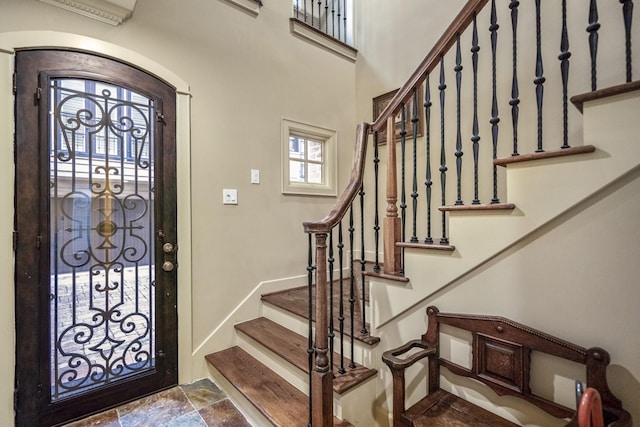 5023 La Branch St, Houston, TX 77004 - foyer with stairs, stone finish flooring, and arched walkways