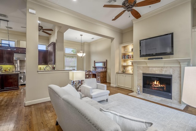 5023 La Branch St, Houston, TX 77004 - living room with a ceiling fan, crown molding, wood finished floors, and a premium fireplace