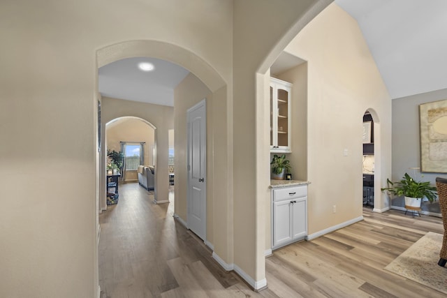 6619 Crystal Forest Trl, Katy, TX 77493 - corridor featuring arched walkways, light wood-style floors, and vaulted ceiling