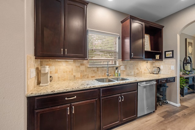 6619 Crystal Forest Trl, Katy, TX 77493 - kitchen with stainless steel dishwasher, light wood-style flooring, tasteful backsplash, light stone countertops, and dark brown cabinetry