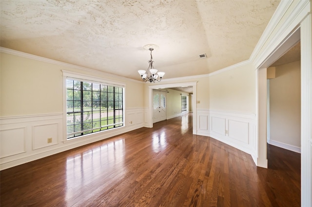 101 Fairway View Ln, Montgomery, TX 77356 - spare room featuring a chandelier, wood finished floors, a wainscoted wall, a textured ceiling, and a decorative wall