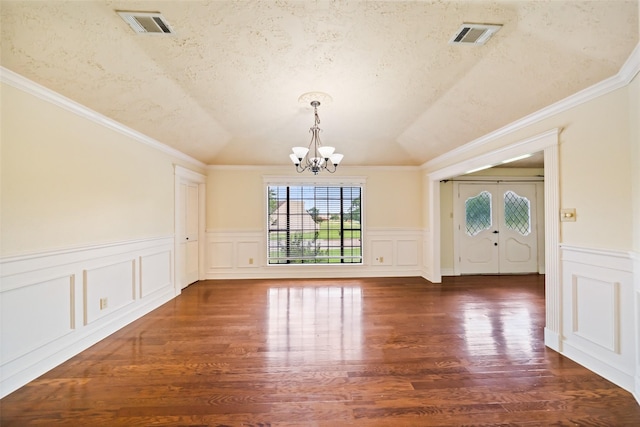 101 Fairway View Ln, Montgomery, TX 77356 - unfurnished dining area with a chandelier, wood finished floors, wainscoting, crown molding, and a decorative wall