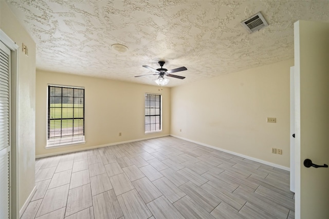 101 Fairway View Ln, Montgomery, TX 77356 - empty room with ceiling fan, plenty of natural light, a textured ceiling, and wood tiled floors