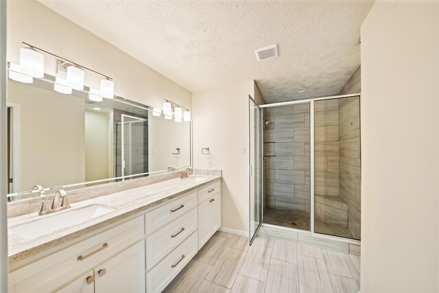 101 Fairway View Ln, Montgomery, TX 77356 - full bath with double vanity, a stall shower, and a textured ceiling