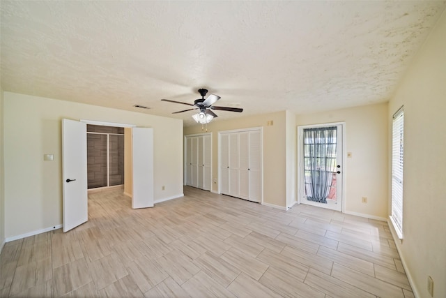 101 Fairway View Ln, Montgomery, TX 77356 - unfurnished bedroom featuring two closets and ceiling fan