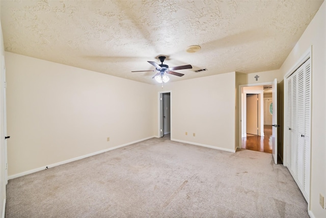 101 Fairway View Ln, Montgomery, TX 77356 - unfurnished bedroom featuring light carpet, a textured ceiling, a closet, and a ceiling fan
