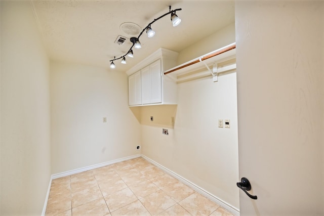 101 Fairway View Ln, Montgomery, TX 77356 - washroom with cabinet space, hookup for an electric dryer, light tile patterned floors, track lighting, and washer hookup