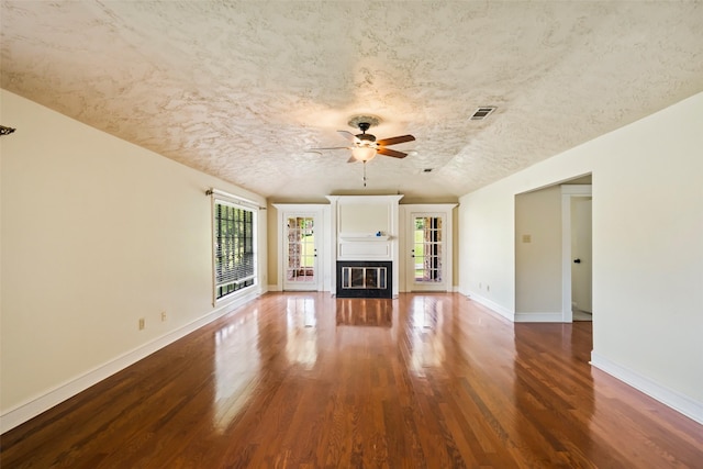 101 Fairway View Ln, Montgomery, TX 77356 - unfurnished living room featuring wood finished floors, a ceiling fan, and a glass covered fireplace
